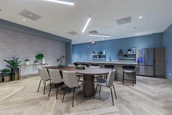 a conference room with a table and chairs and a kitchen at The Citizen at Shirlington Village in Virginia 22206